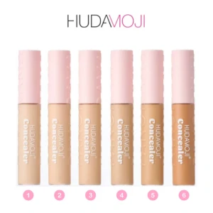 Set de seis correctores Hudamoji en tonos beige, desde claro a oscuro, presentados verticalmente con tapas rosas y etiquetas blancas. Ideal para cubrir ojeras y manchas.