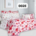 Plumón floral con estampado de flores rojas y moradas sobre fondo blanco, presentado en cama con sábanas a juego.