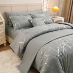 Funda duvet gris con diseño mármol plateado, vista frontal en cama con cojines y mesitas de noche.