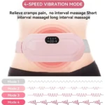 Cinturón de masaje térmico rosa con panel digital, en uso sobre abdomen. Muestra cuatro modos de vibración con ondas gráficas.