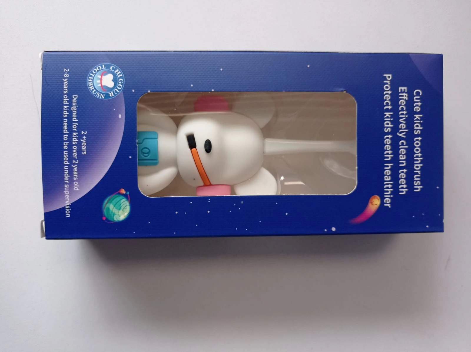 Caja azul con ventana transparente mostrando cepillo dental de nieve animada, diseñado para niños pequeños.