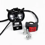 Luz LED doble color 40W con forma de búho, montura negra y cableado visible, junto a interruptor rojo y tornillos de instalación.
