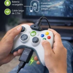 Control Xbox 360 blanco con cable USB de carga integrado, en uso mientras se juega, con texto que indica hasta 35 horas de batería por carga.