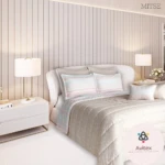 Edredón acolchado doble faz en cama doble, con tonos suaves y detalles en pastel. Incluye cojines combinados y ambiente luminoso.