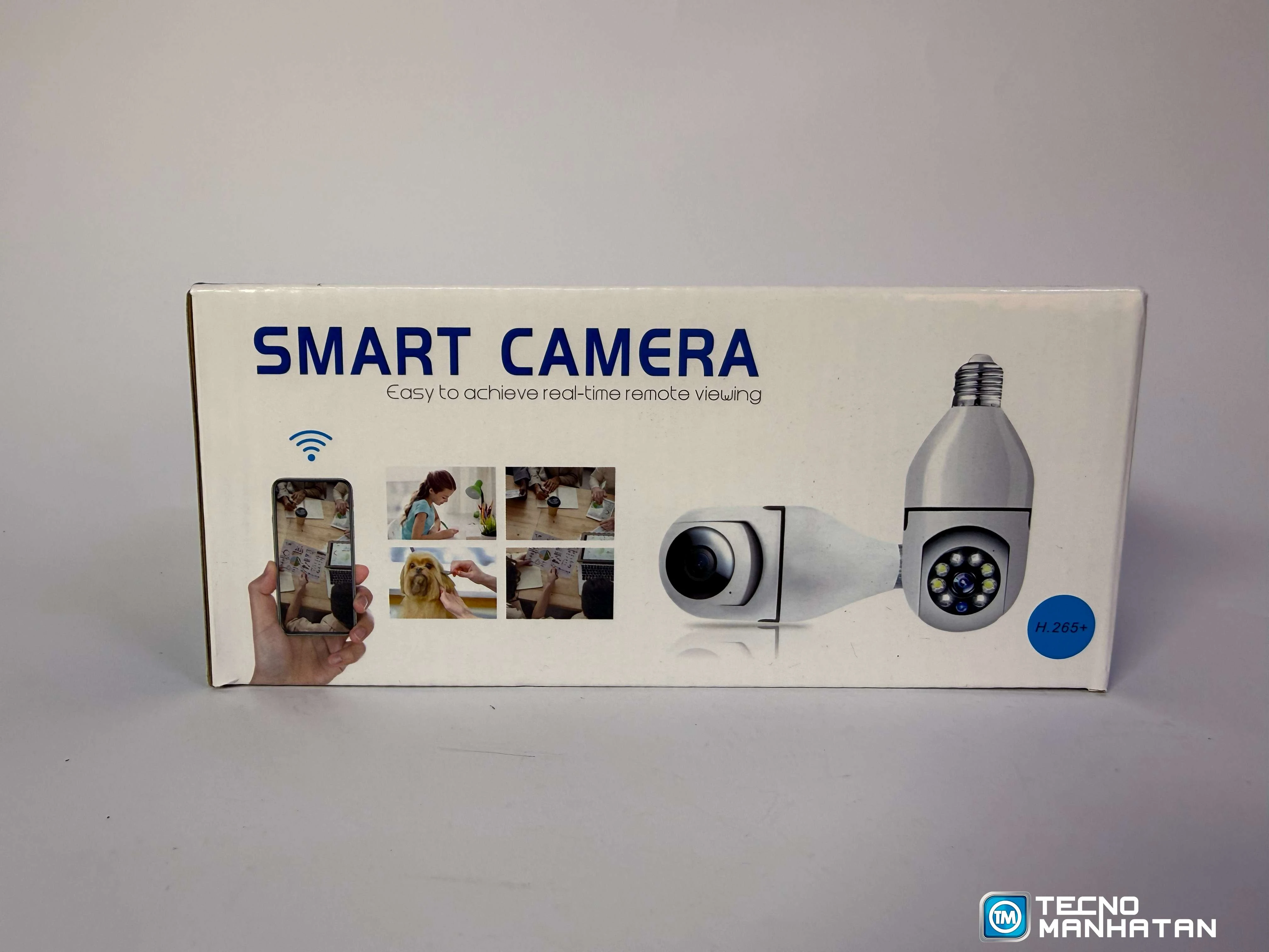Cámara smart HD blanca con visión nocturna, control remoto y sensor de movimiento. Caja con ilustraciones de uso en hogar y celular.
