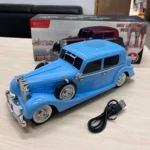 Carro parlante azul estilo Mercedes-Benz 770 con luces LED, reproductor de música y cable USB incluido, sobre superficie clara con caja original al fondo.