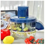 Peladora automática de frutas y ajos inalámbrica en color azul, con mango ergonómico y base transparente que muestra uvas verdes y trozos de fruta procesada.