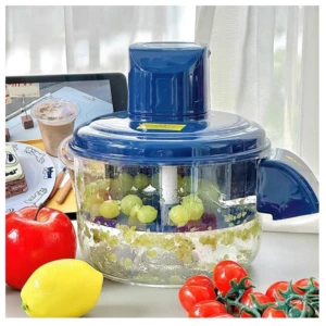 Peladora automática de frutas y ajos inalámbrica en color azul, con mango ergonómico y base transparente que muestra uvas verdes y trozos de fruta procesada.