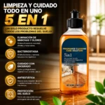 Botella de 100 ml de solución de limpieza 5 en 1 para pisos, con etiqueta azul y naranja, sobre superficie brillante con hojas verdes al frente.