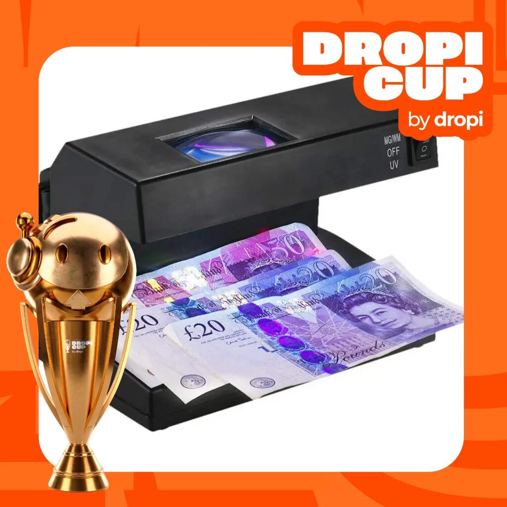 Detector de billetes falsos con luz UV y lupa, mostrando billetes de 20 libras siendo verificados en su bandeja de entrada.