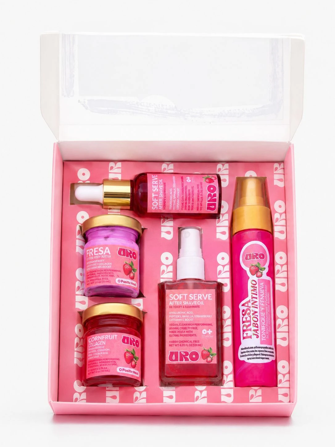Kit de viaje en caja rosa con cinco productos: dos frascos de crema, un frasco de jabón íntimo, un spray y un tubo de colágeno. Todos con etiquetas en tonos rosas y dorados.