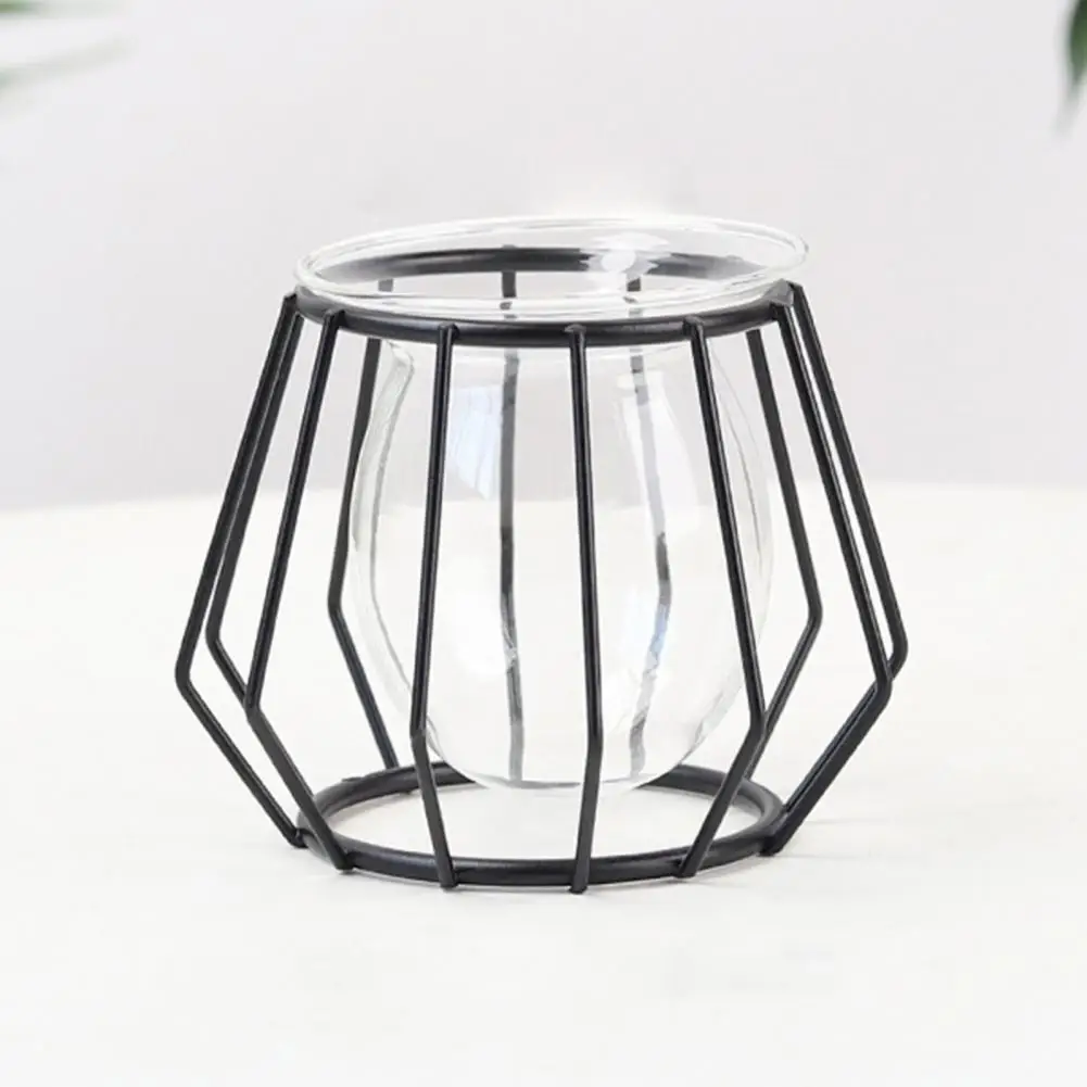 Macetero geométrico metálico negro con base de vidrio transparente, diseño minimalista para espacios modernos.