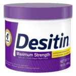 Tubo de crema Desitin Máxima Protección, 454g, con óxido de zinc al 40%, para prevenir pañalitis en bebés. Envase blanco con tapa y etiqueta morada.