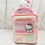 Alcancía tipo cajero electrónico en rosa con diseño de Hello Kitty, incluye teclado numérico, ranura para monedas y llave decorativa.