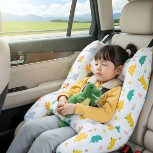 Cojín ergonómico H para bebé con soporte cervical, color blanco con estampado de dinosaurios y patitos, en uso en asiento trasero de vehículo.