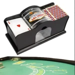 Barajador manual mecánico negro con diseño de Las Vegas, mostrando cartas de juego y tapete verde de casino en primer plano.