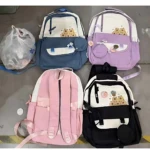Cuatro mochilas juveniles con estampado de girasoles, en colores azul, lila, rosa y negro, dispuestas sobre suelo de baldosas.
