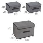 Caja organizadora de tela gris con tapa y velcro, en tres tamaños: 26.5 cm, 37.5 cm y 24 cm de altura, ideal para guardar ropa y accesorios.