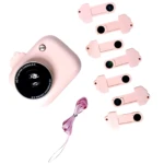 Cámara proyector infantil rosa con lente frontal y seis discos intercambiables en tonos pastel, junto a un cordón de seguridad.