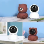 Camara Wifi Oso 3398-4 con diseño de peluche en color marrón y blanco, mostrando la lente frontal y el cuerpo redondeado sobre superficie clara.