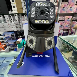 Cámara wifi triple lente de color negro con antenas, montada sobre su caja azul en mostrador de tienda.
