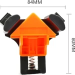 Clip de fijación angular naranja con resortes negros, dimensiones 84x80 mm, para ensamblaje preciso de muebles y marcos.
