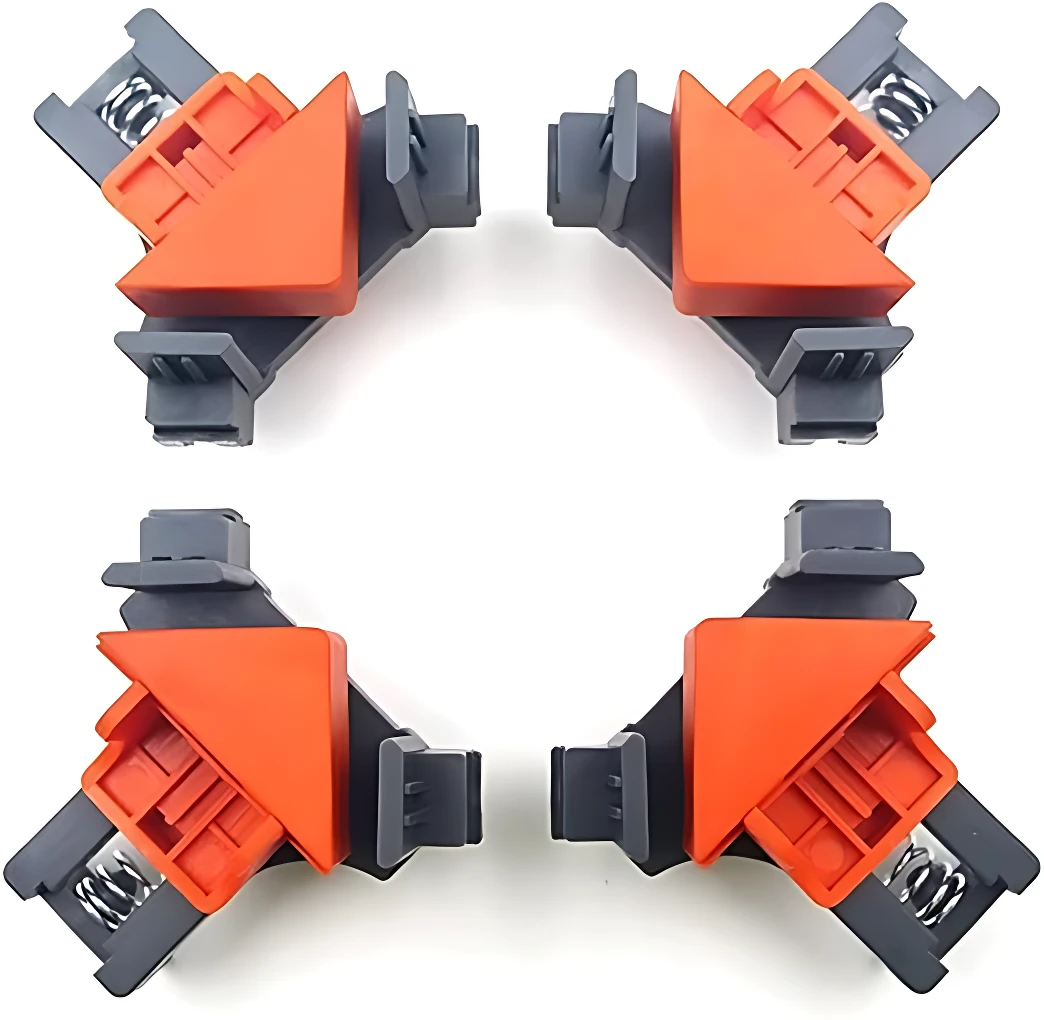 Cuatro clips de fijación angular en naranja y gris, dispuestos en cuadrícula, para ensamblaje preciso de muebles y marcos.