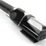Cortador eléctrico recargable negro con mango ergonómico, cabezal transparente y cepillo integrado para eliminar puntas abiertas.