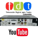 Decodificador TDT DVB-T2 negro con conectores RCA, HDMI y antena WiFi. Logos TDT Colombia y YouTube visibles.