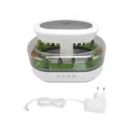 Difusor humidificador LED blanco con luz nocturna y sonido lluvia, incluye base con plantas decorativas y cargador USB.
