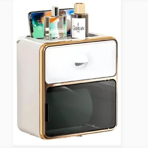 Dispensador de papel higiénico blanco con detalles dorados, incluye estante superior para accesorios de baño.