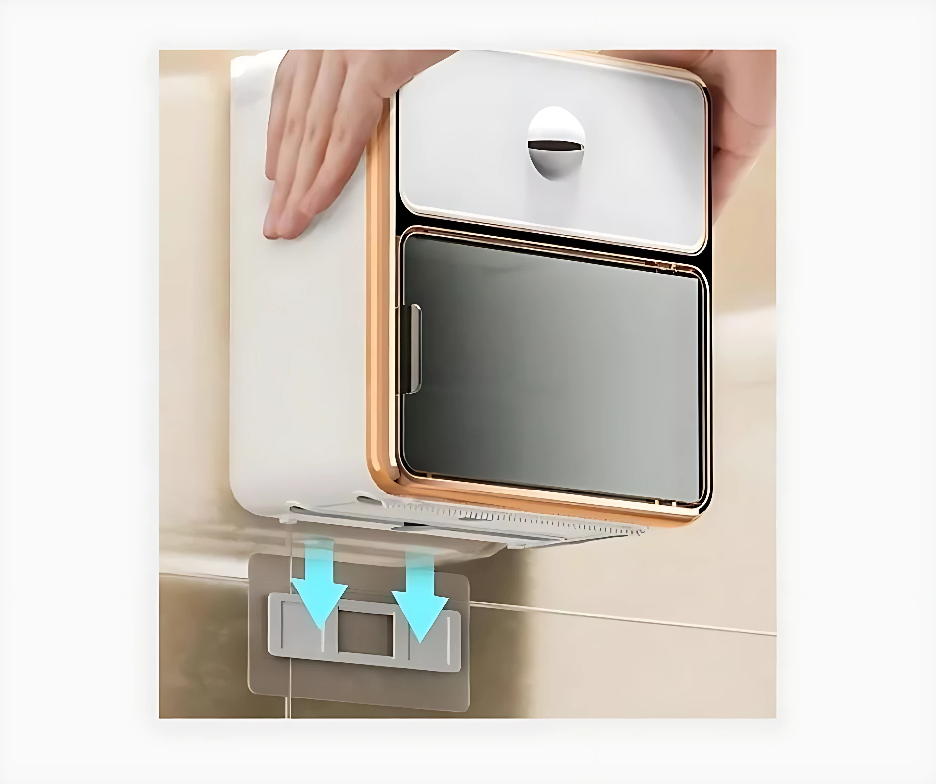 Dispensador de papel higiénico blanco con cajón superior y estante inferior, montado en pared beige con adhesivo transparente visible.