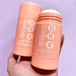 Dos unidades de cera anti frizz fijadora Milagros en presentación de barra, color salmón claro, con tapa blanca y etiqueta que indica control de frizz y brillo natural.