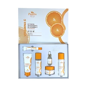 Kit facial Paulis Skin Care con Vitamina C en caja abierta, mostrando cinco productos: tubo, frasco, ampolla, jarra y botella, sobre fondo blanco con diseño de naranjas.