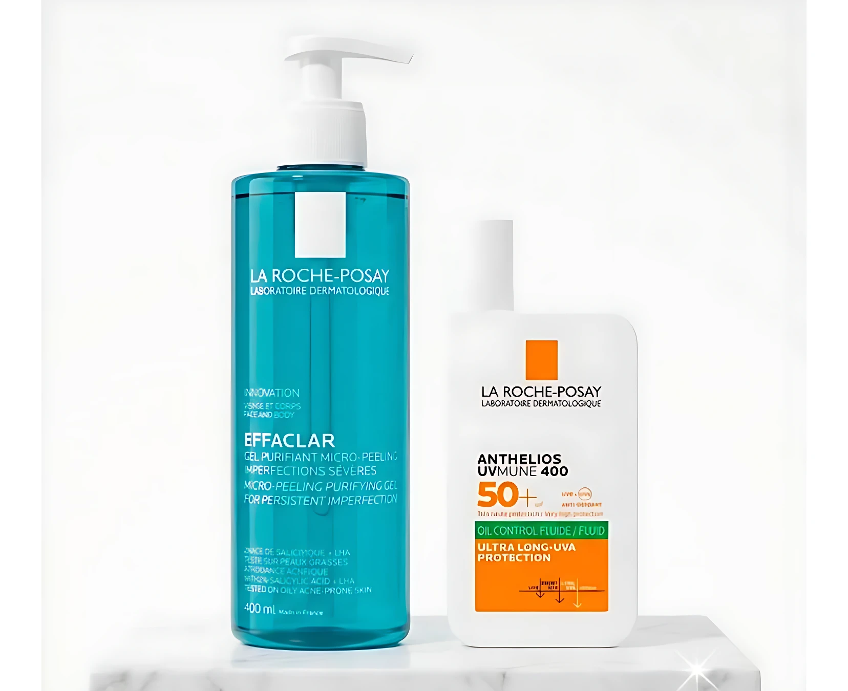Kit de dos productos La Roche-Posay: jabón Effaclar en envase azul con bomba y protector solar Anthelios en envase blanco con tapa, ambos sobre superficie blanca.