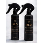 Dos botellas negras de spray termoactivo KLD, con etiqueta dorada y texto en español, mostrando 200 ml cada una, dispuestas lado a lado sobre superficie clara.