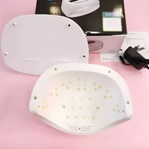 Lámpara LED de uñas T3, color blanco, vista superior con LEDs internos y base desmontable. Incluye caja, cargador y manual.