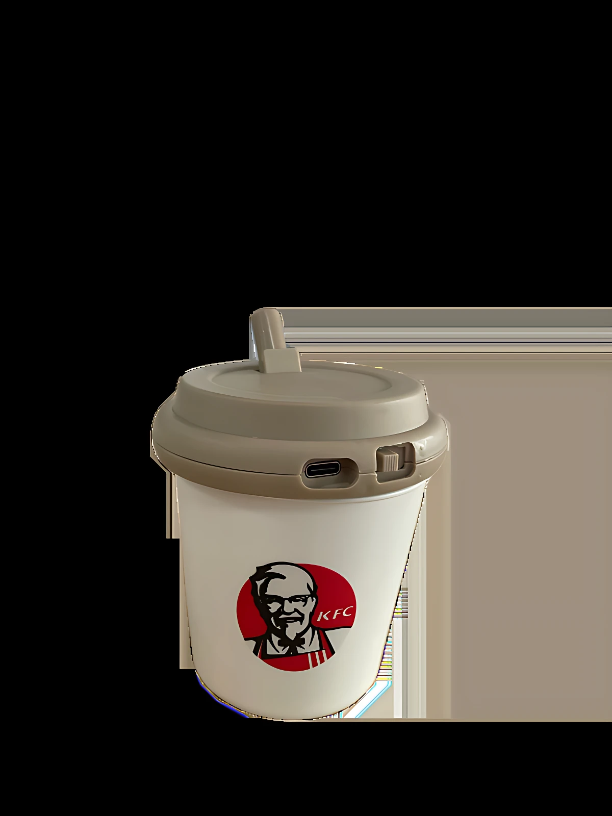 Vaso de café con tapa gris y logo de KFC, parte de set de lámpara nocturna infantil con diseño temático.