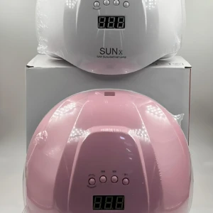 Lámpara UV LED Sun 54W en blanco y rosa, con base desmontable, mostrando dos unidades apiladas sobre su caja original.