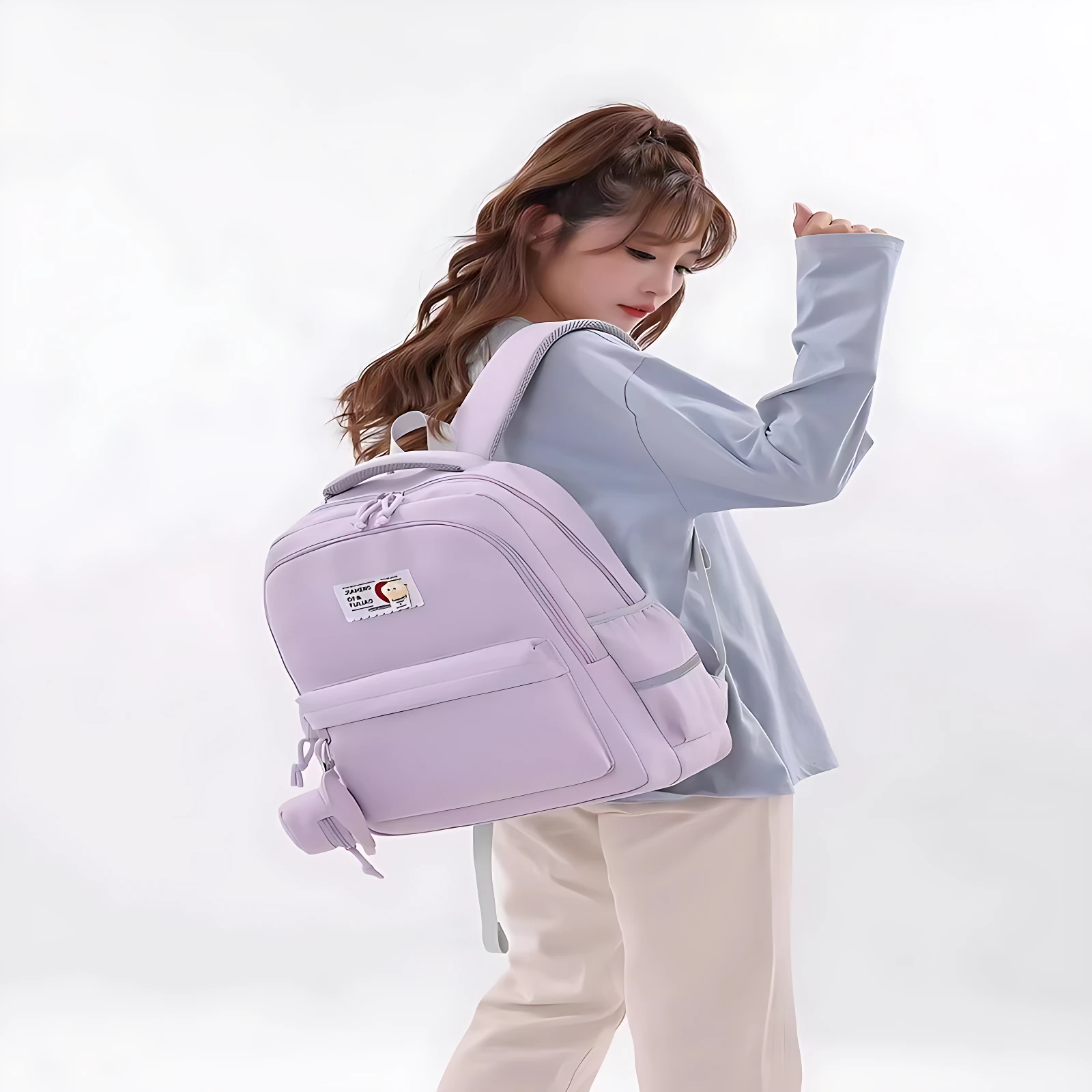 Mochila escolar Jiaheng en tono lila claro, con diseño ergonómico y compartimento para portátil de 15.6 pulgadas.