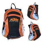 Mochila KTM Racing en naranja, negro y blanco, con logotipo visible y diseño deportivo. Muestra tres ángulos: frontal, lateral y trasero.