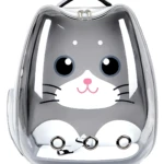 Maleta tipo cápsula transparente con diseño de gato gris y blanco, asa superior y tres anillos metálicos en la base.
