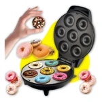 Máquina Donera X 7 con placas antiadherentes negras, abierta mostrando siete cavidades redondas y donas horneadas de colores.