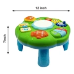 Mesa didáctica sensorial verde con piano, espejo central y botones interactivos; mide 12 pulgadas de ancho por 7 de alto, ideal para estimulación temprana.