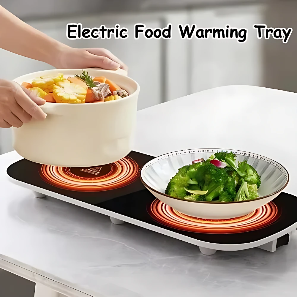 Plato eléctrico calentador con dos zonas de calefacción, superficie negra con anillos rojos visibles, sobre mesa blanca; una persona coloca olla con comida y otro plato con ensalada verde encima.