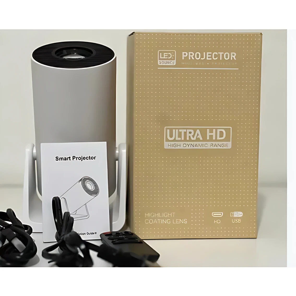 Proyector LED Y300 en color gris, acompañado de su caja de cartón beige, manual, cables y control remoto sobre superficie blanca.