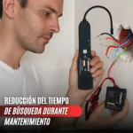 Hombre usando rastreador de cables no invasivo negro con antena curva, detectando líneas ocultas en pared con cables expuestos; incluye receptor portátil con cables rojos y negros.