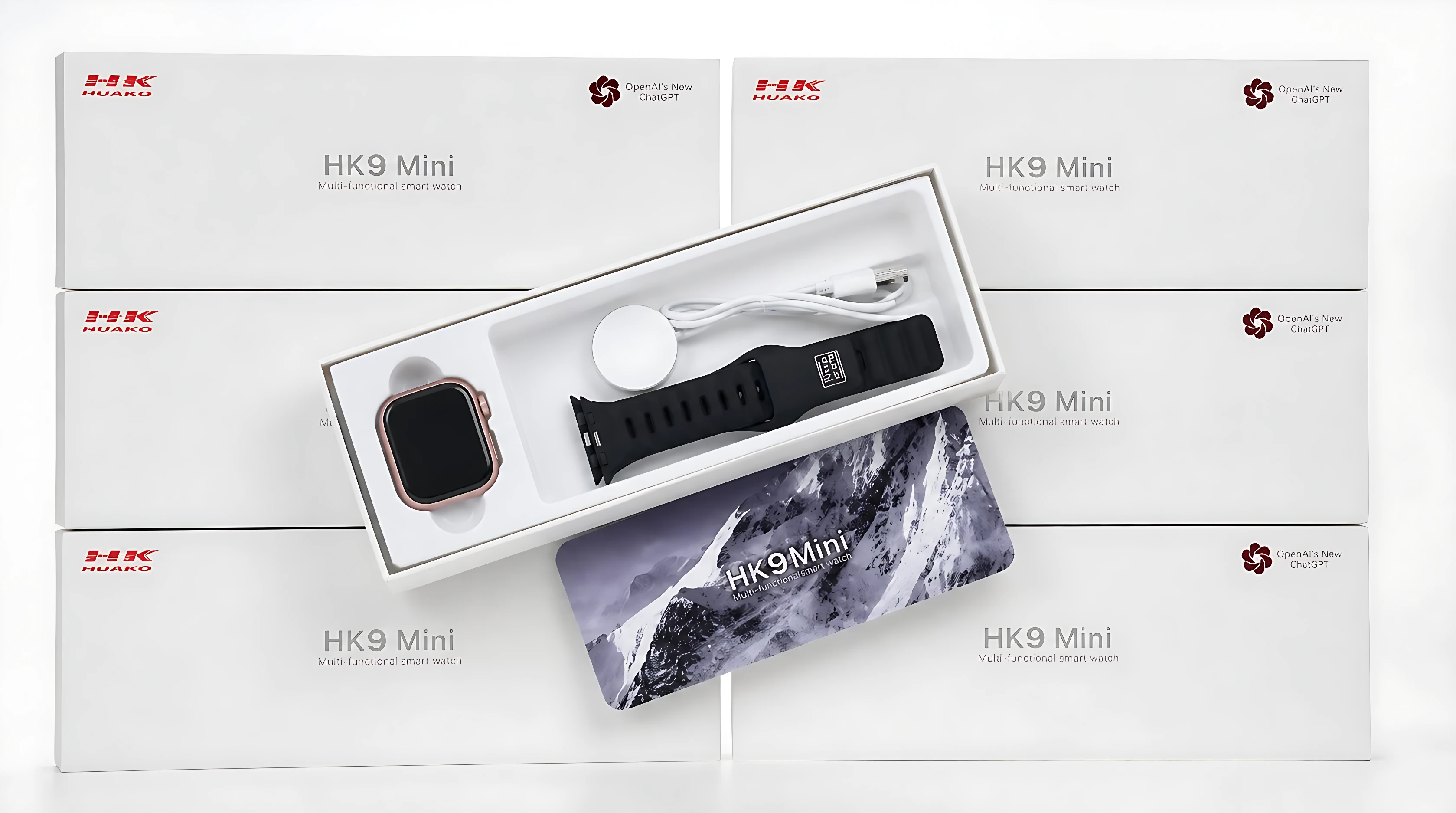 Reloj inteligente HK9 Mini en caja abierta, mostrando pantalla cuadrada, correa negra, cargador y cable. Fondo con múltiples cajas blancas del modelo.