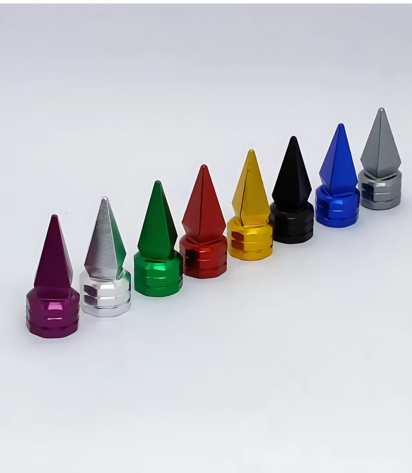 Set de tres tapas de válvula tipo spike en aluminio, disponibles en colores negro, azul, rojo, verde, amarillo, plateado y morado, con acabado brillante y diseño puntiagudo para estética agresiva.