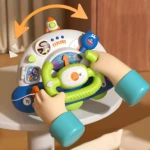Volante de simulación espacial blanco y verde con palanca, luces y figuras interactivas para niños, montado en mesa alta.